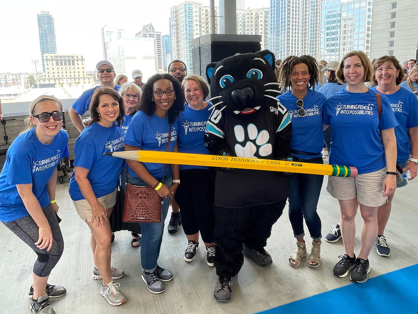 Domtar employee volunteers give back throughout the year. Pictured: Group of Domtar employees with Sir Purr (Carolina Panthers mascot) at Classroom Central event.