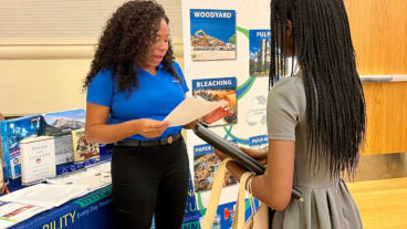 A Domtar recruiter at an HBCU career fair speaks with a potential candidate.