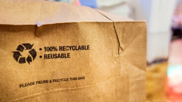 Image: Bottom of brown paper bag with recycling symbol and words 100% recyclable and reusable. The FTC Green Guides help ensure accuracy of environmental claims. Learn what Domtar and our industry are suggesting for the updated guide.