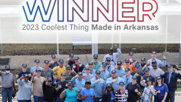 Our fluff pulp was named as the coolest thing made in Arkansas. Image: Group of Ashdown Mill employees below banner that says WINNER 2023 Coolest Thing Made in Arkansas.