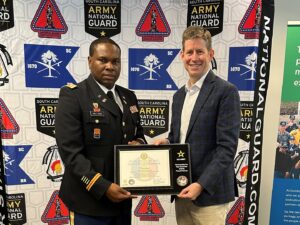 U.S. Army Lt. Col. Julian Milligan (left) presents Paper Excellence Group Paper & Packaging President Steve Henry with a plaque commemorating Domtar becoming a U.S. Army PaYS partner.