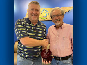 DeWayne Bone (left), ex-officio general chairman of the Pulp and Paper Safety Association’s board of directors, and Paper and Packaging’s senior director of health and safety, presents the PPSA Distinguished Service Award to Randy Adams, Kingsport Mill health and safety manager.