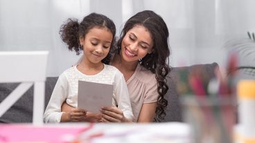 Mother and daughter looking at a card together