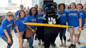 Domtar employee volunteers give back throughout the year. Pictured: Group of Domtar employees with Sir Purr (Carolina Panthers mascot) at Classroom Central event.