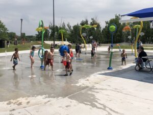 Nekoosa splash pad at Krautzer Recreational Plaza. Kids playing in splash pad on a hot summer day.