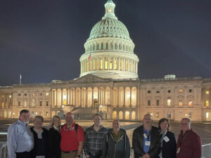 Domtar pulp and paper workers stand in front of the U.S. Capitol building.