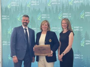 Domtar's Bonny Skene, center, receives an FPAC award as the 2023 Outstanding Member of the Year. Pictured left: Derek Nighbor, right: Kate Lindsay.